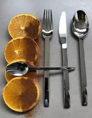 Silverware set with lemon slices on a gray surface