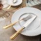 Belo Inox Alma cutlery with 24K gold plated handles placed on white ceramic plates in an elegant table setting