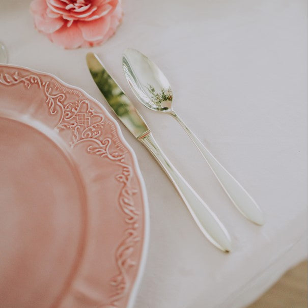 Belo Inox Belo 6 cutlery set detail styled on an elegant pink table setting with floral décor