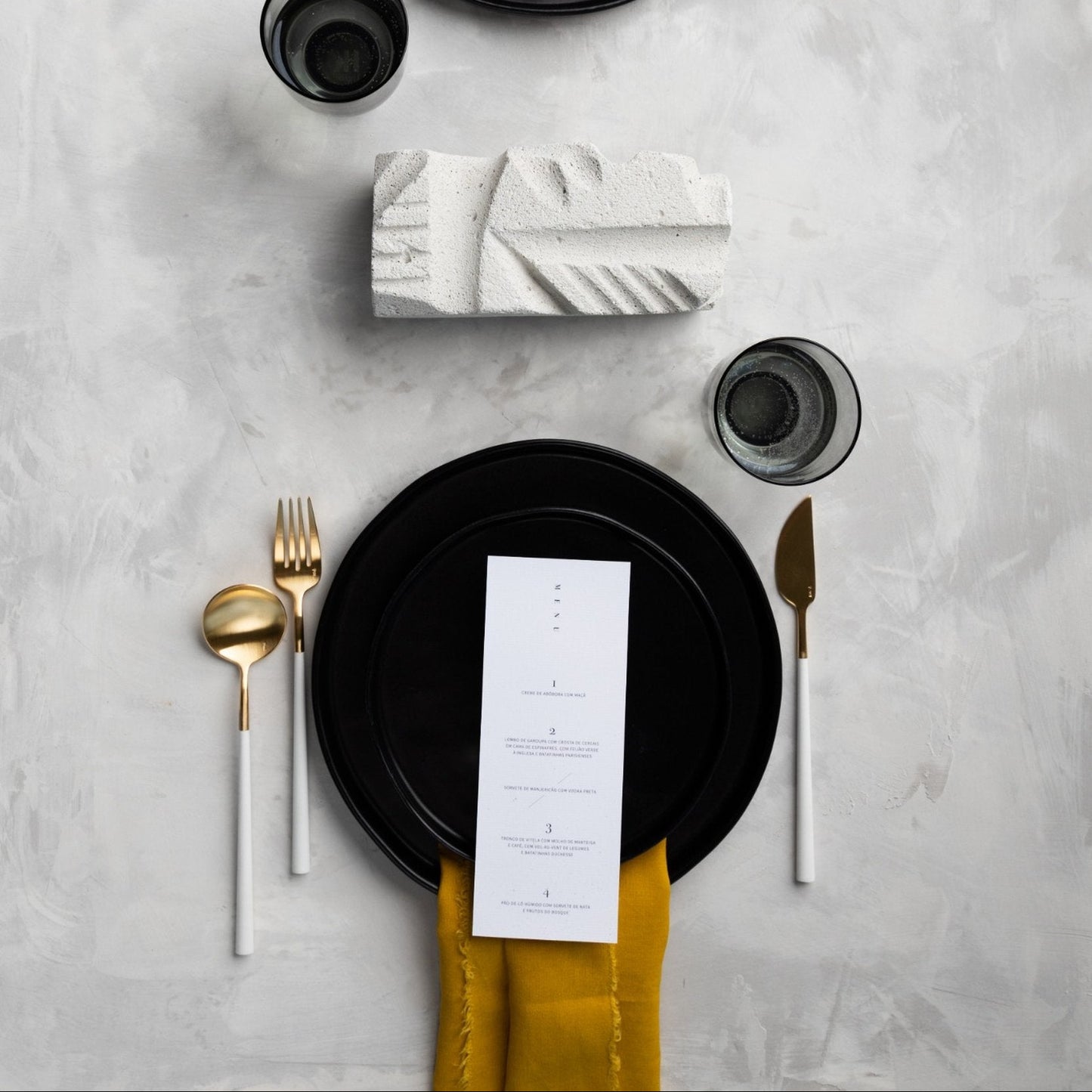 Belo Inox NEO White cutlery in brushed gold finish displayed in an elegant table setting