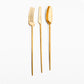 Belo Inox TWO gold polished cutlery set — modern long-handle spoon, knife and fork on a light background