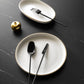 Belo Inox TWO high-shine black PVD cutlery set displayed on elegant dark table setting with white plates