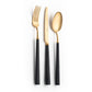 Belo Inox Yume flatware set in brushed gold with black resin handles on white background