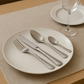 Lifestyle photo of the Bright Kitchen  Silverline stainless steel cutlery set on an elegant dining table