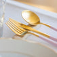 Cutipol GOA Pink Gold matte cutlery set displayed on a light table setting with fork, knife and spoon in focus