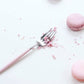 Cutipol GOA Pink fork with pink macaron crumbs on a white background