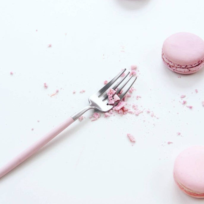 Cutipol GOA Pink fork with pink macaron crumbs on a white background