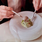 Cutipol GOA White matte fork and spoon being used to serve a gourmet dish on a white plate