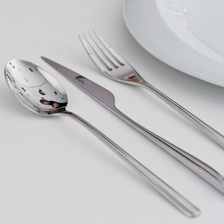Cutipol Icon cutlery set in polished stainless steel with table fork, table knife and table spoon displayed on a white surface.
