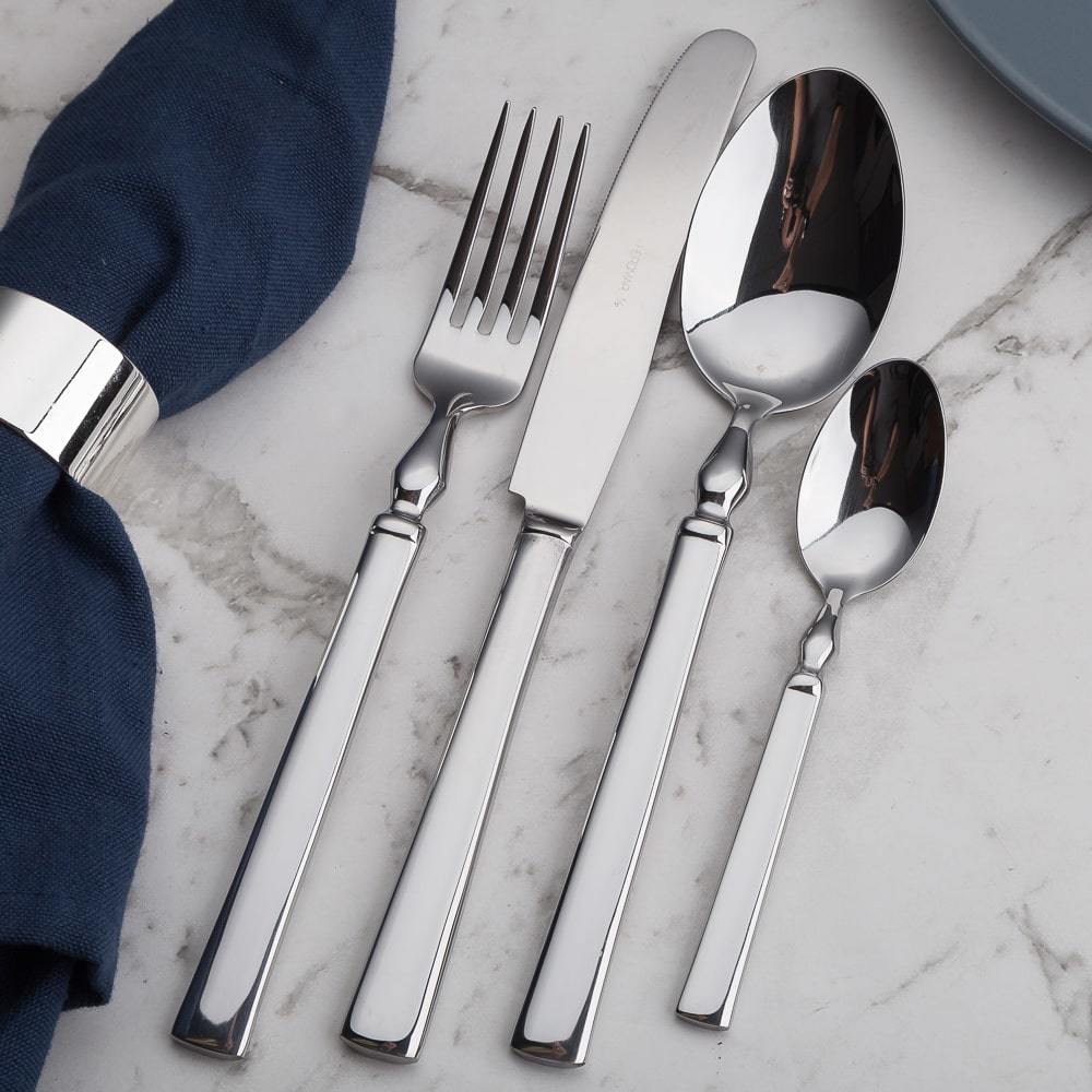 Herdmar Celta Cutlery Set in 18/10 polished stainless steel, displayed on a marble table with a blue napkin – elegant lifestyle table setting