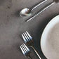 Herdmar Stick 18/10 stainless steel cutlery displayed on a modern table, highlighting its elongated minimalist design.