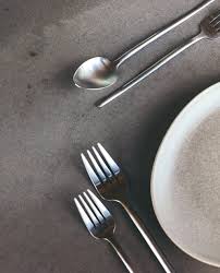 Herdmar Stick 18/10 stainless steel cutlery displayed on a modern table, highlighting its elongated minimalist design.