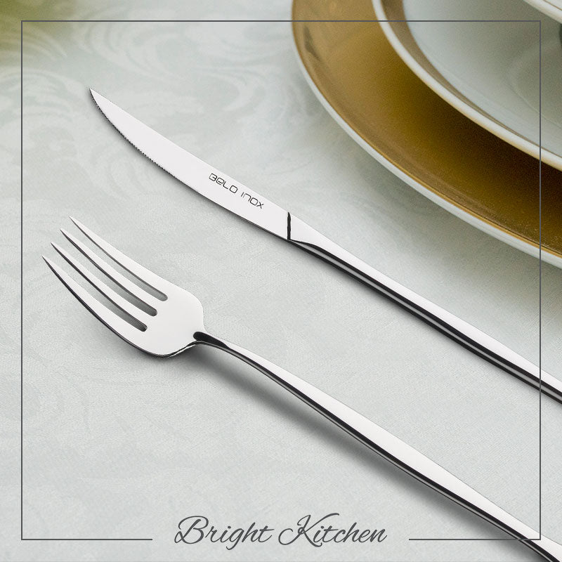 Belo Inox Luna stainless steel cutlery set displayed on a table setting with elegant plates, showcasing modern minimalist Portuguese design.