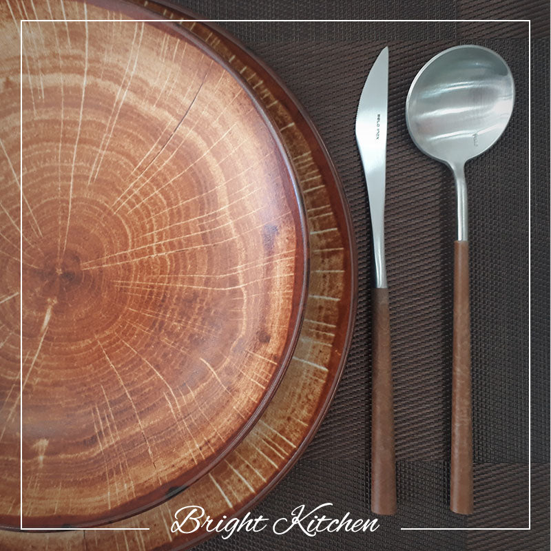 Belo Inox Neo Brown cutlery set styled on a wooden plate – stainless steel and brown resin handles, handcrafted in Portugal