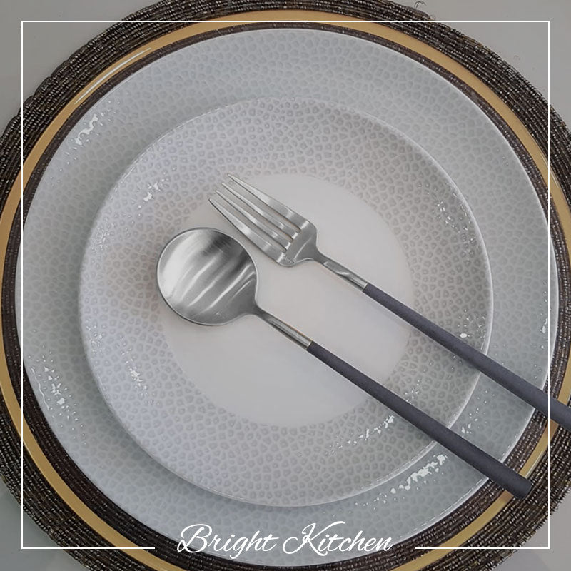 Belo Inox Neo Grey cutlery set – elegant table styling with grey resin handles and brushed stainless steel finish. Bright Kitchen lifestyle photo.