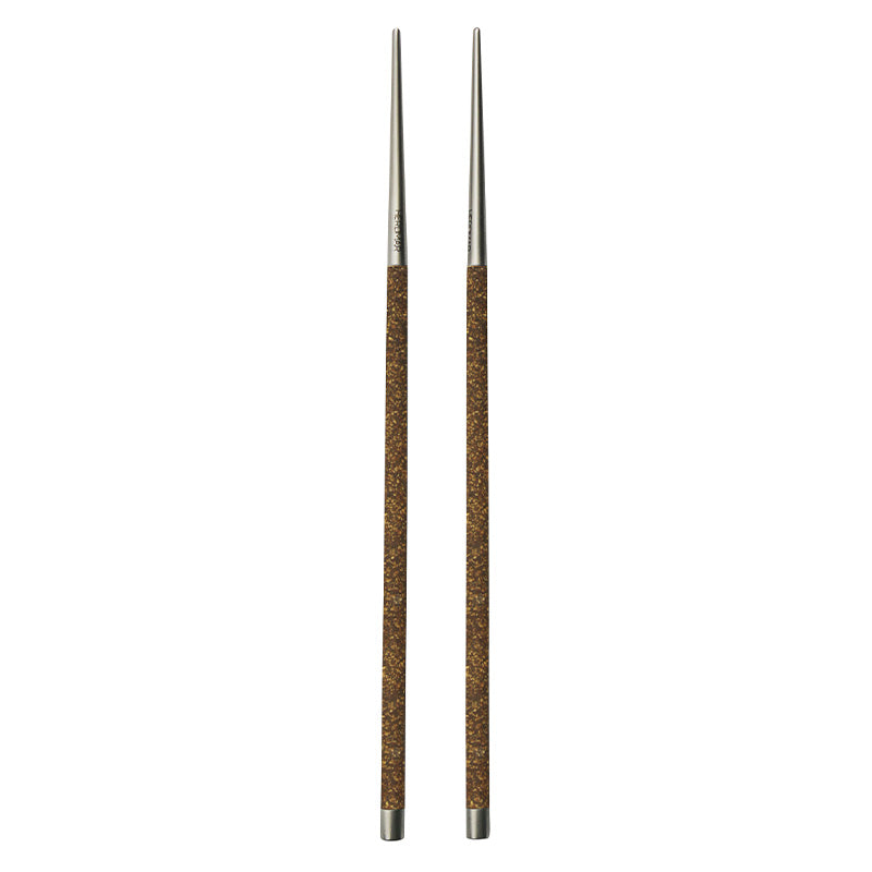 Herdmar NOHC stainless steel chopsticks with textured brown handles, blending Asian inspiration with Portuguese craftsmanship.